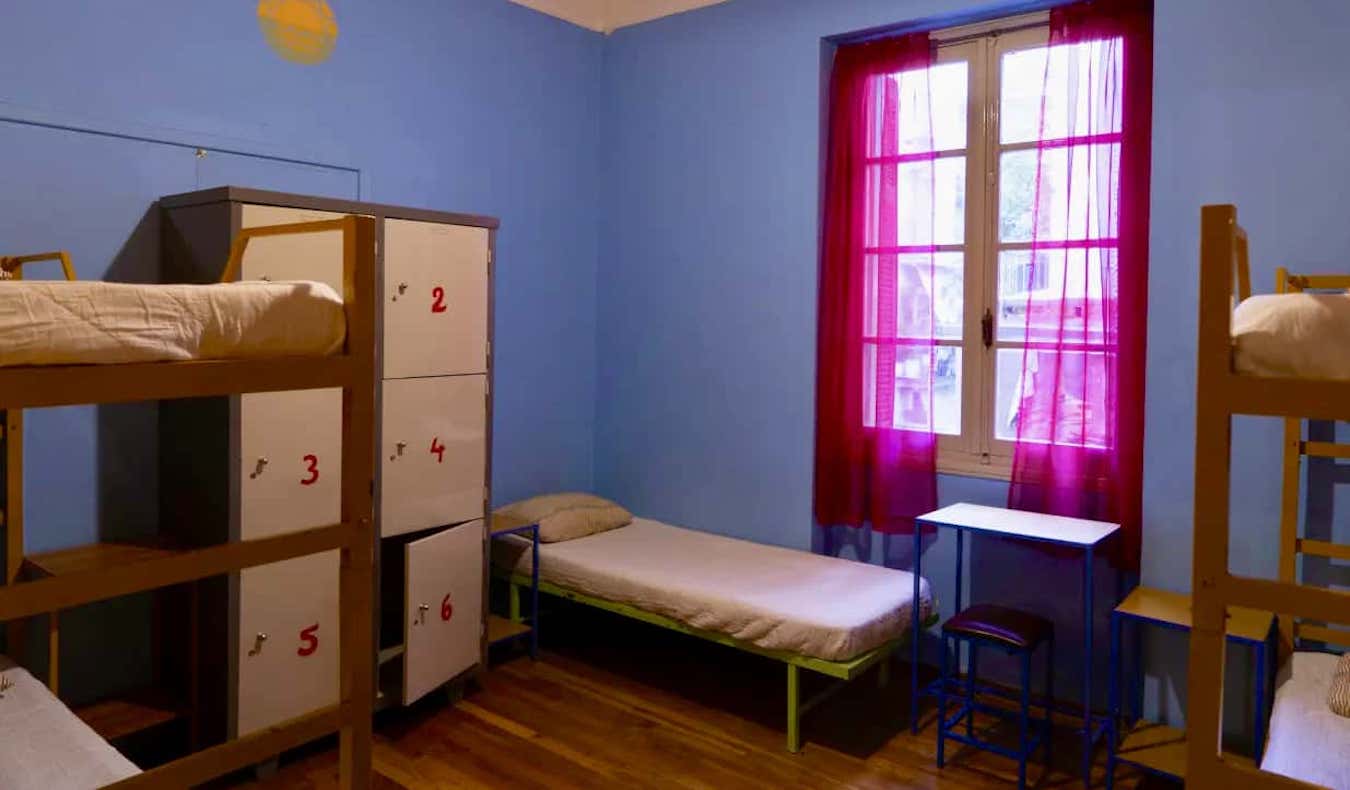A small dorm room with lockers in the Pagration Youth Hostel in Athens, Greece