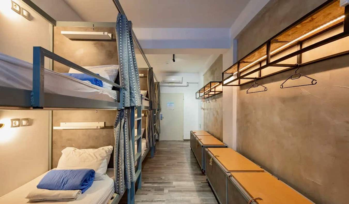 Cozy beds with curtains in a dorm room at the Bedbox hostel in Athens