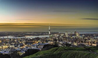 The stunning skyline of Auckland, New Zealand during a colorful dusk sunset