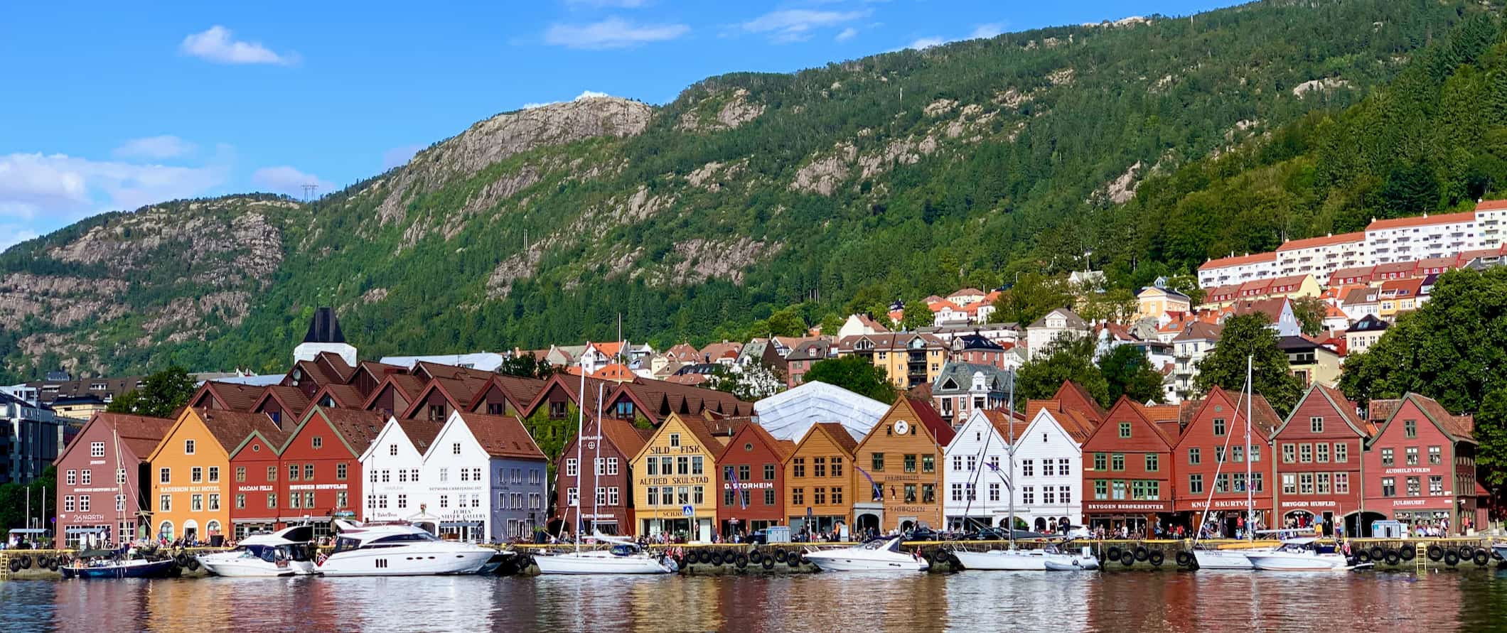A row of colorful old buildings along the calm shores of Bergen, Norway 