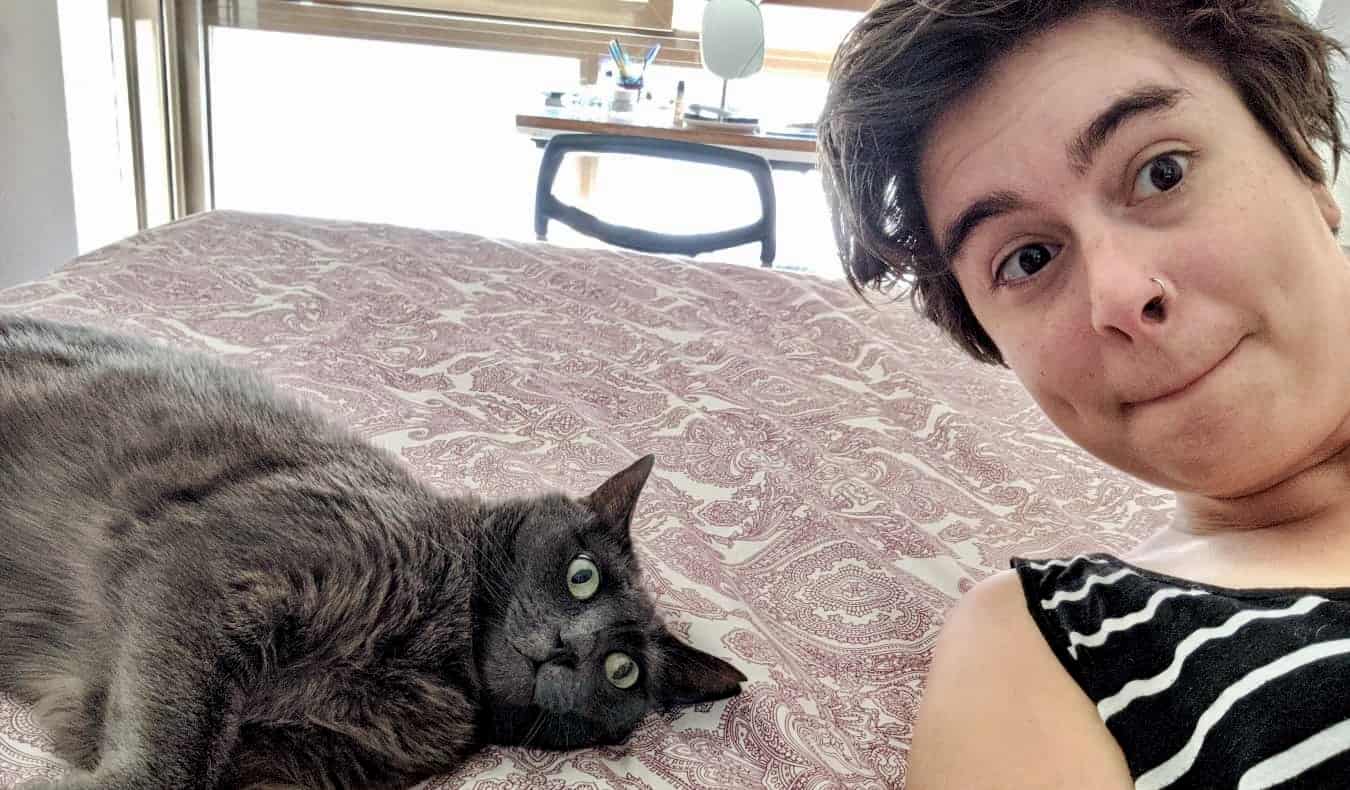 House sitter Sam and a cat posing for a fun photo