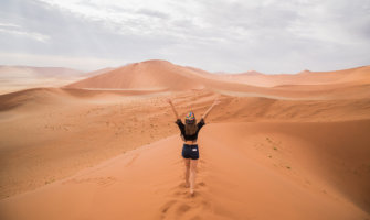 Kristin Addis walking on a sand dune