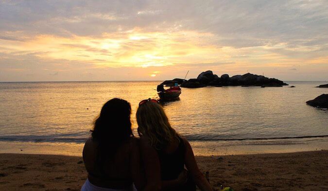 A Lesbian couple staring out into the sunset
