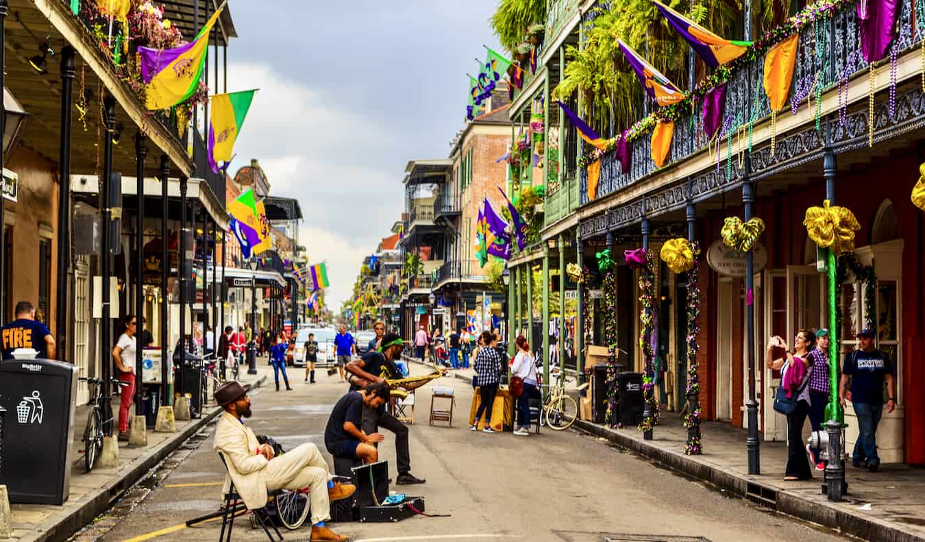People walking and playing music in the French Quarter of bustling New Orleans, USA