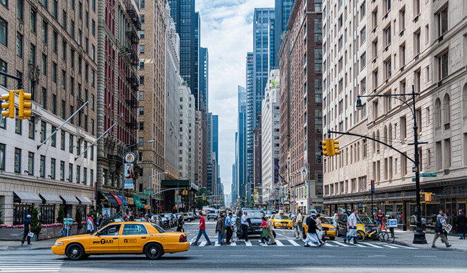The best places to stay in New York City New York City street scene yellow taxi people and crossing the street