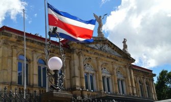 The Costa Rican flag waving in front of the historic theater in San José, Costa Rica