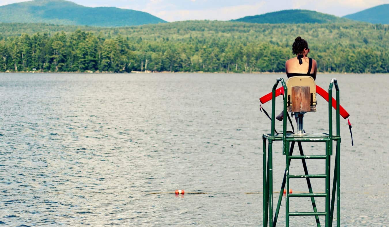 A lifeguard on duty at a small freshwater beach in the summer