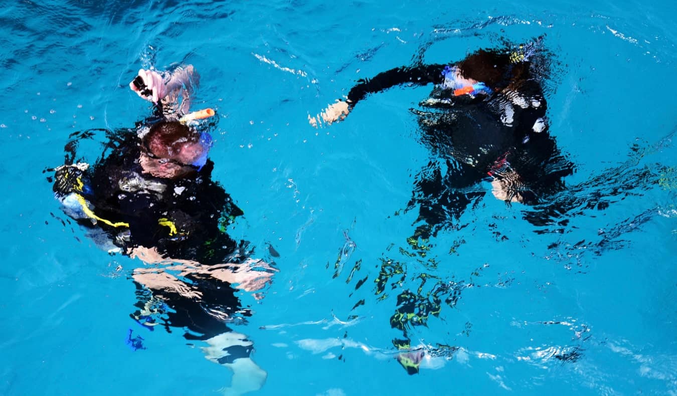 A pair of scuba divers preparing to dive in Australia